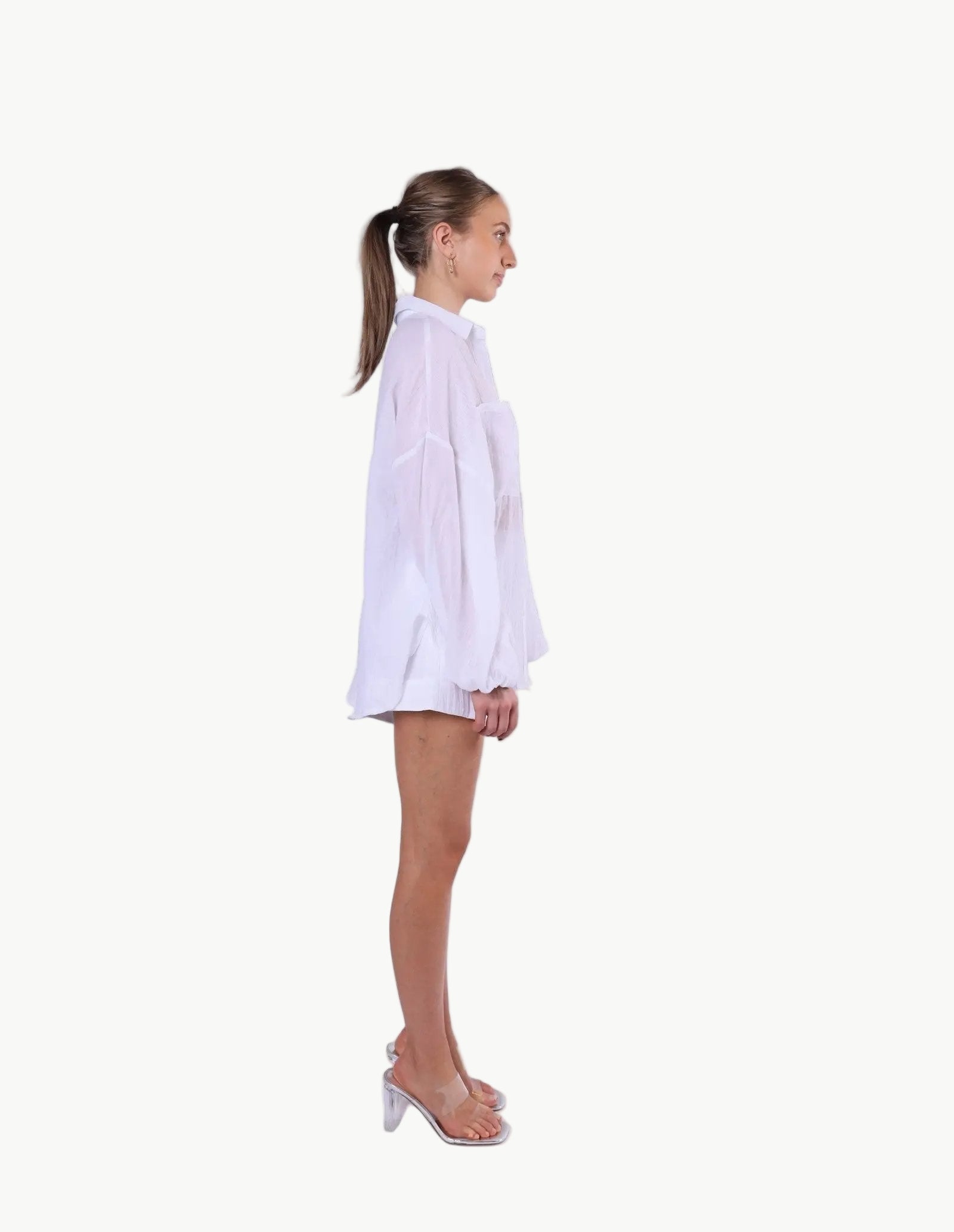 La Libéré model  wearing a white shirt on a plain background